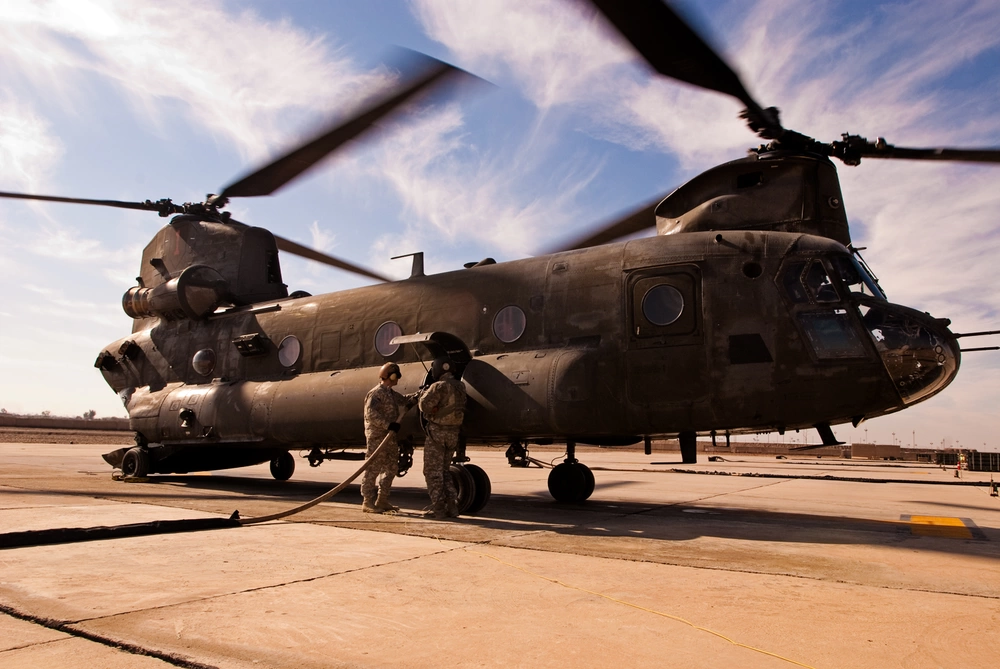 A CH-47 Chinook helicopter deployed with Enhanced Combat Aviation Brigade, 1st Infantry Division receives fuel at the Forward Arming and Refueling Point on Camp Taji, Iraq. Source. Spc. Roland Hale.