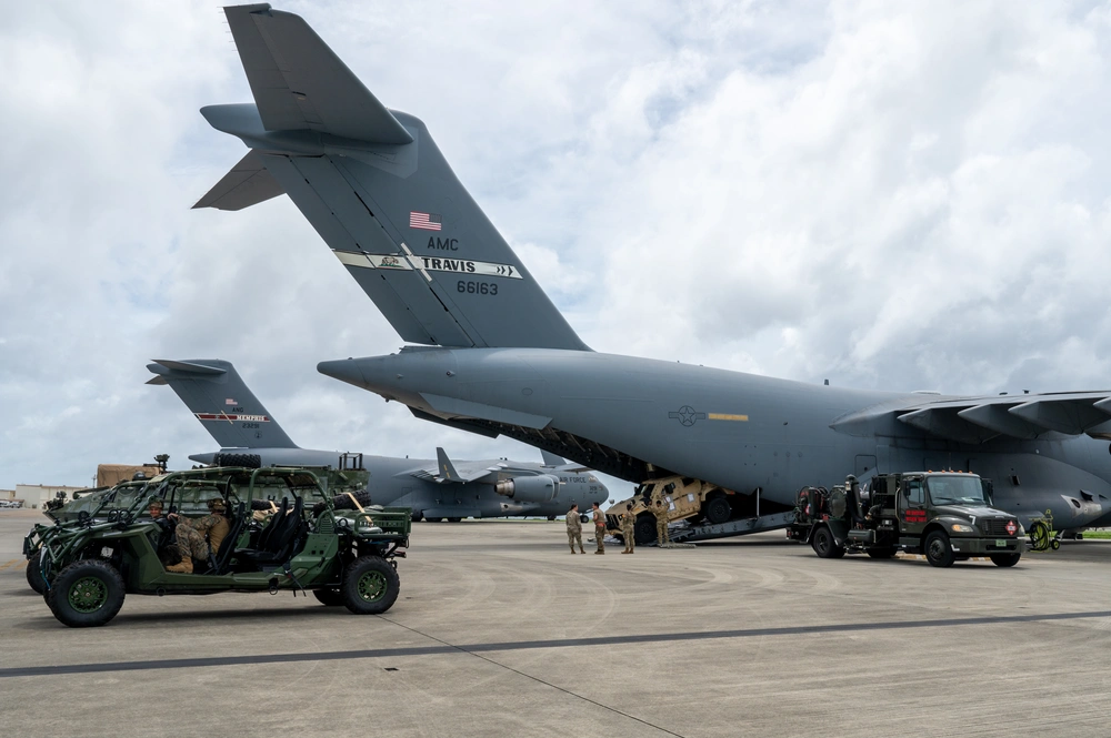 Loading military vehicles on a C-17 Globemaster III assigned to 60th Air Mobility Wing at Kadena Air Base, Japan. Source. Airman 1st Class Arnet Tamayo.
